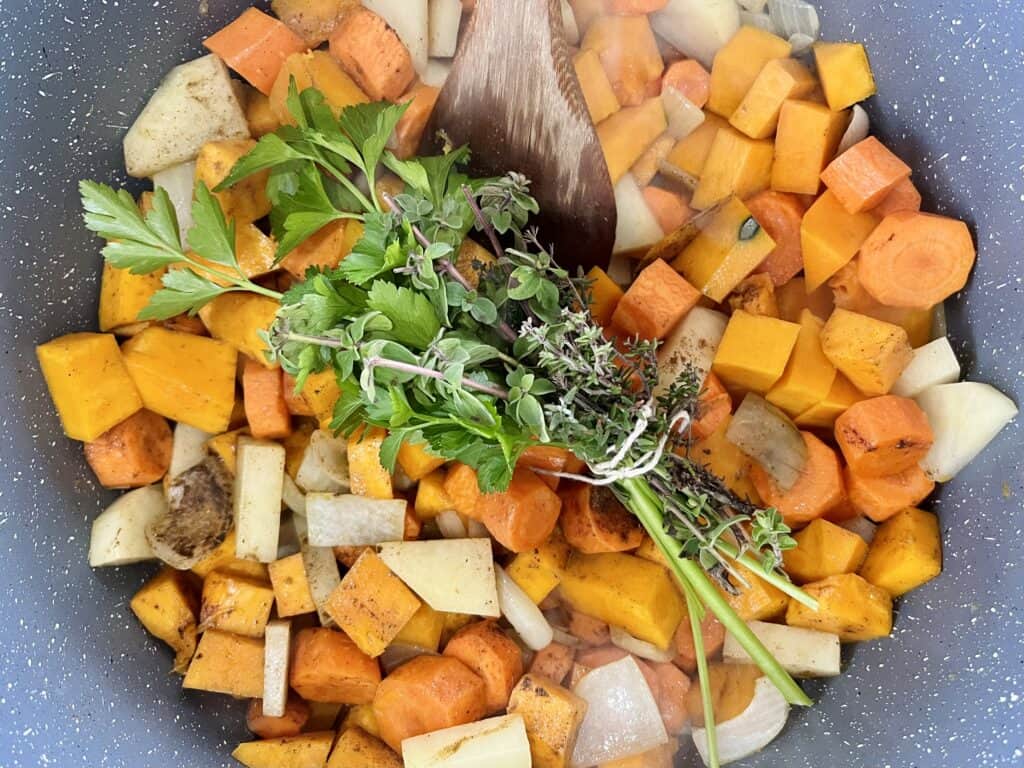 Vegetables frying in pot for farmhouse pumpkin soup